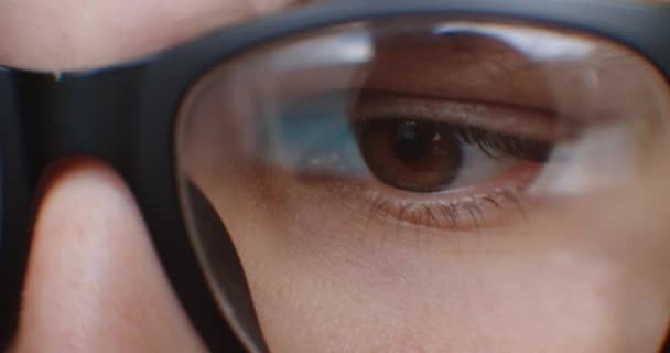 Close-up of a man looking at the screen with glasses and takes them off and rubs them from fatigue. Eye fatigue from the screen — Stock Video