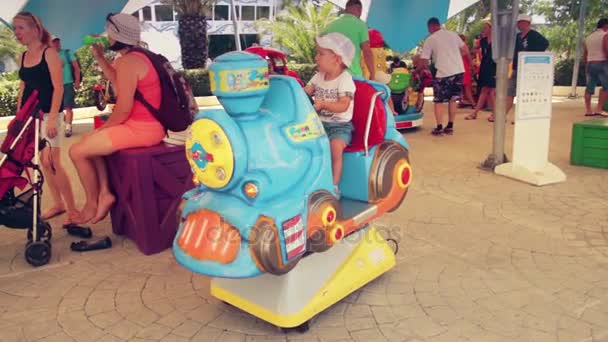 Adler, Rusland - 25 juli 2016: Baby jongenskind rijden toy trein in luna park. — Stockvideo