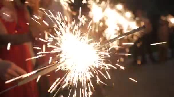 Firework sparkler burning with lights in background — Stock Video