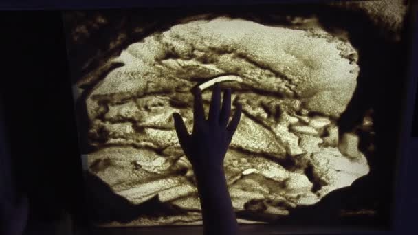 Sand animation. Child drawing sand on a white screen with hands — 비디오