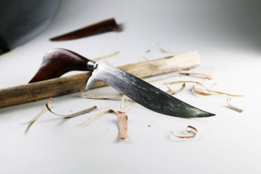 Pocket knives with wood scraps. clipart