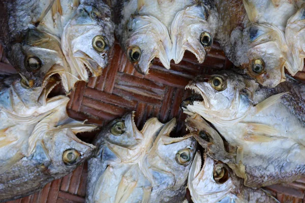 Dried salted fish on the baskets.