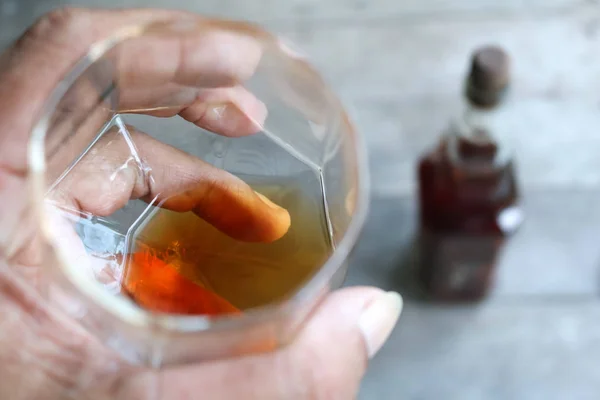 Local whiskey in a glass with bottle of herbal liquor. — Stock Photo, Image