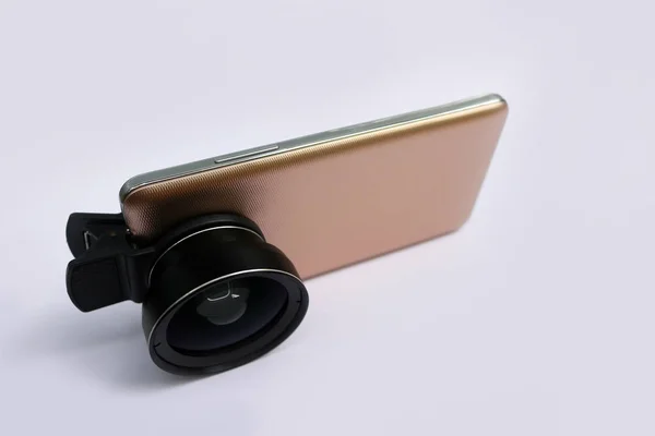 Clip lens with mobile phones in white background.