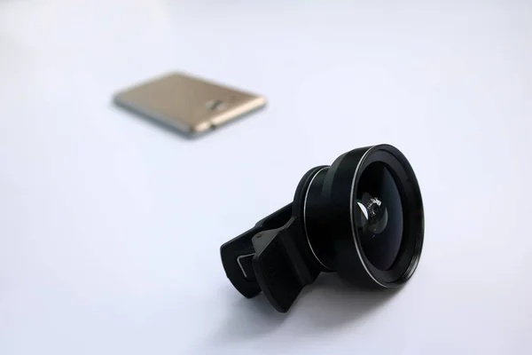 Clip lens with mobile phones in white background.