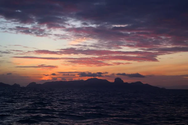 Las nubes y el cielo rojo púrpura antes del amanecer en el océano —  Fotos de Stock