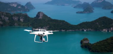 Drone kamera veya Uav okyanus ve ada ile mavi gökyüzünde uçan