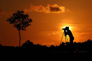 Fotoğrafçı dışarıda fotoğraf çekiyor, kadın zekasının silueti.