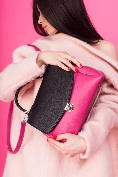 Pink colored photo - close seup handbag and women holding it — стоковое фото