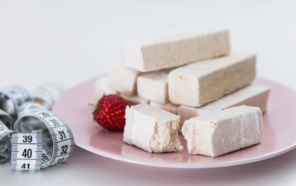 Diet dessert with strawberry with measure tape