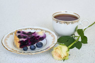 Bir yaban mersini turtası, fincan siyah çay ve beyaz bir arka planda - natürmort gıda beyaz gül