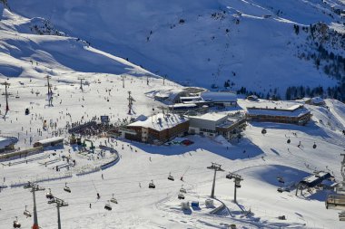 Ischgl, Avusturya - 25 Aralık 2017: Tyrol Alpleri'nde Kayak Bankası güneşli Aralık günü '. Chairlifts ve teleferik insanlarla dolu, kalabalık önünde girişidir. Kafe ve restoranlar kayakçılar için açık olan