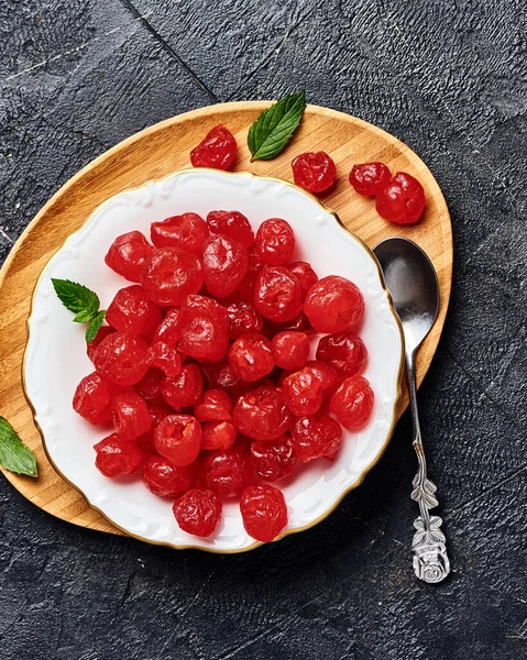 Candied dried cherry on plate. Top view of berries.