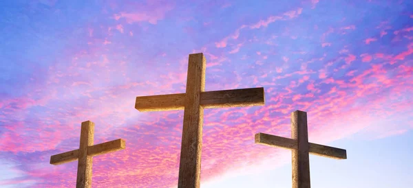 Three Crosses against a bright sunrise sky