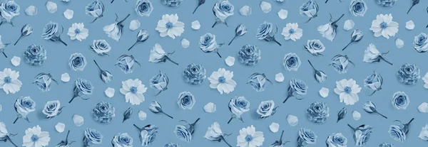 Floral pattern made of blue flowers and rosebuds. Flat lay, top view. Summer or spring background. Flower background. Banner of flowers. Flowers pattern texture