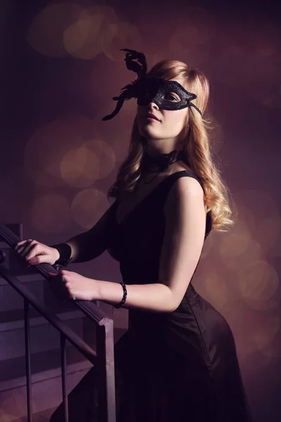 Beautiful girl in black mask — Stock Photo, Image