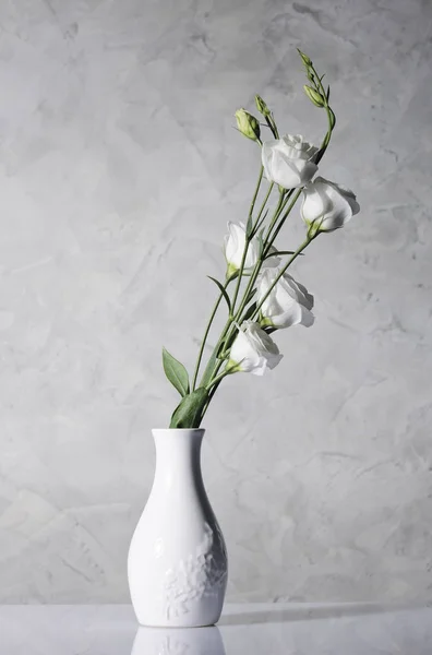 Beautiful flowers in white vase — Stock Photo, Image