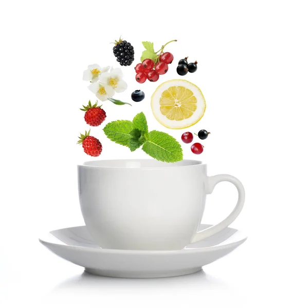 Cup of tea with herbs, fruits and berries — Stock Photo, Image