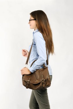 Beyaz arka planda günlük kıyafetler içinde güzel bir kız.