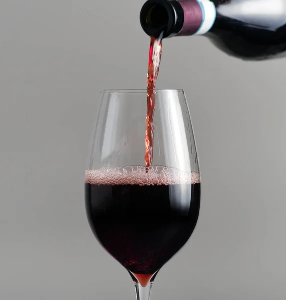 把红酒从瓶子里倒进杯子里 — 图库照片