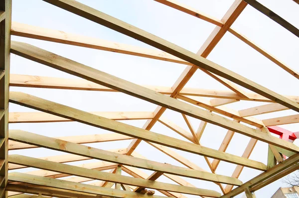 The wooden structure of the building. Wooden frame building. Wooden roof construction. photo for home. house building. Installation of wooden beams at construction the roof