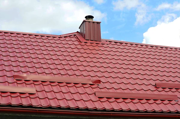 Primer plano de la nueva chimenea de tubería y la protección del techo de snowboard (Snow guard) en la construcción de la casa. sistema de calefacción individual. Sistema de calefacción de tuberías coaxiales Casa Tubería de chimenea coaxial . — Foto de Stock