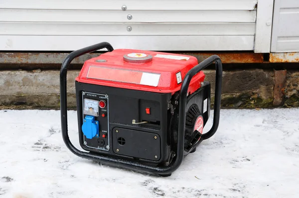 Portable electric generator. Generator running in the cold winter.