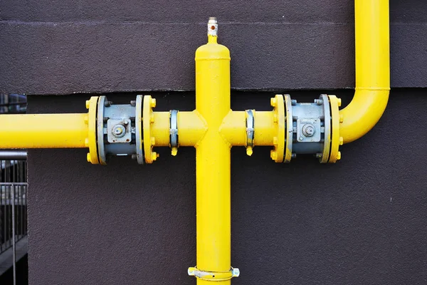 Yellow gas pipe with a crane and gear — Stock Photo, Image