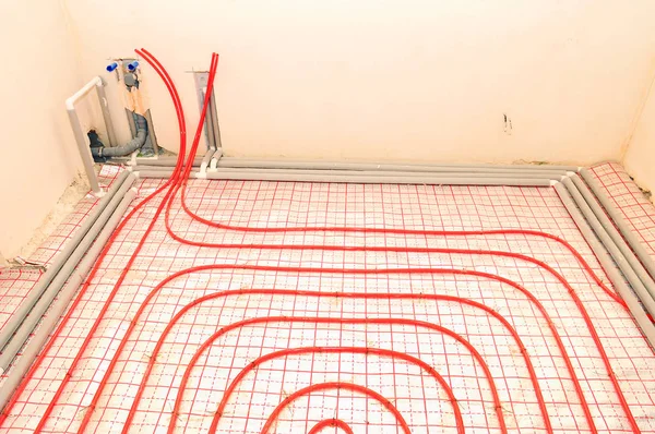 Underfloor heating installation. Close up on water floor heating system interior. plumbing pipes.  Individual Heating.