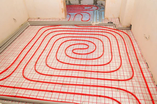 Underfloor heating installation. Close up on water floor heating system interior. plumbing pipes.  Individual Heating.