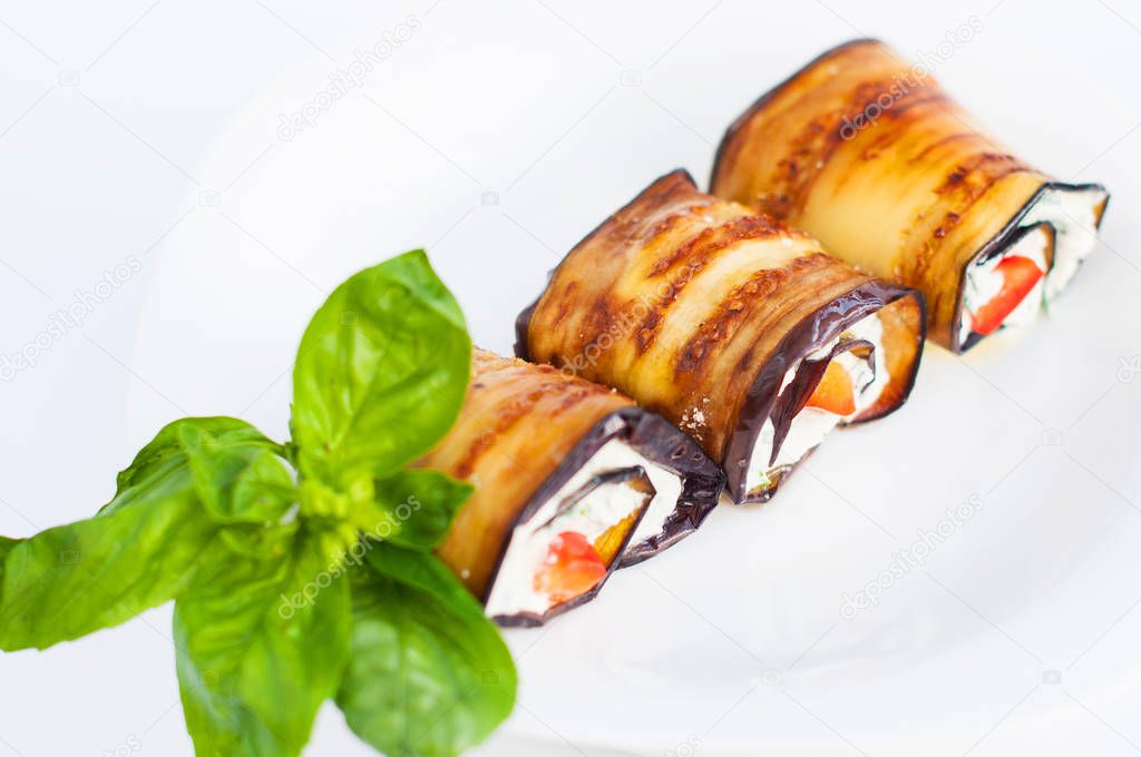 Tasty eggplant rolls stuffed with cottage cheese.close-up