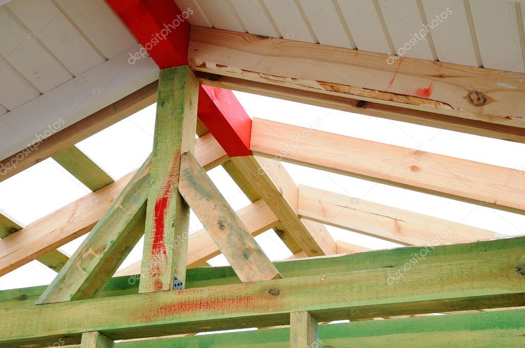 The wooden structure of the building. Wooden frame building. Wooden roof construction. photo for home. house building. Installation of wooden beams at construction the roof truss system of the house.