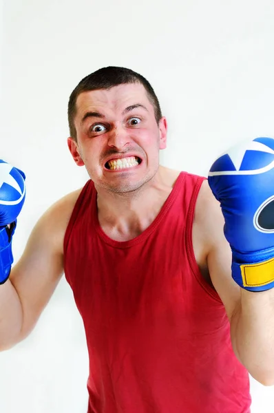 Boxer man with boxing gloves. Young handsome male athlete with boxing gloves, boxer working out, fitness Studio shot. Evil boxer man's face. — Stock Photo, Image