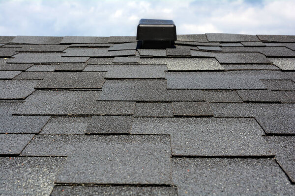 Close up view on Asphalt Roofing Shingles Background. Roof Shingles - Roofing.