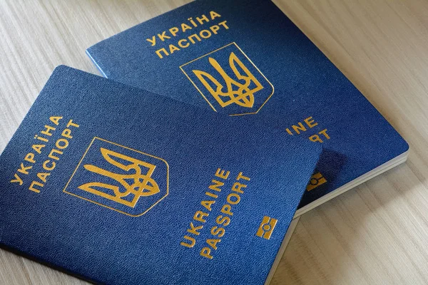 New ukrainian blue biometric passport with identification chip on wooden background with copy space. — Stock Photo, Image