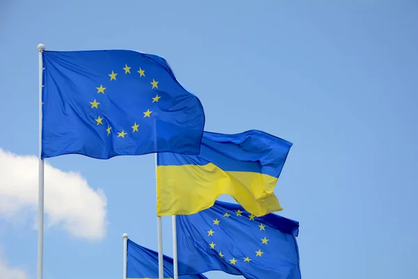 Прапори України та Європейського Союзу (ЄС) розвіваються на вітрі — стокове фото