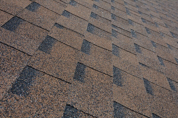 Close up view on Asphalt Roofing Shingles Background. Roof Shingles - Roofing.