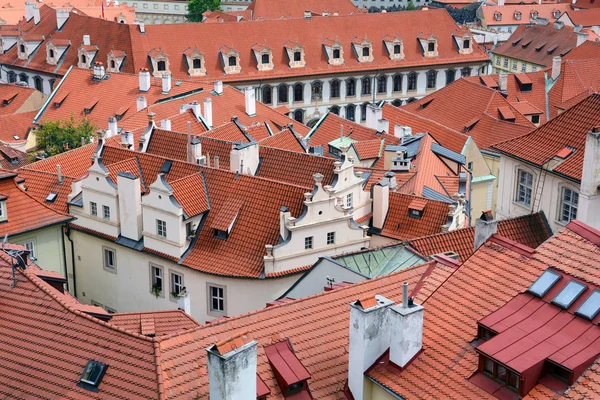 The old town's ceramic tiles rooftops, Prague, Czech Republic. Red Shingles Roof with attic and  skylights windows. — Stock Photo, Image