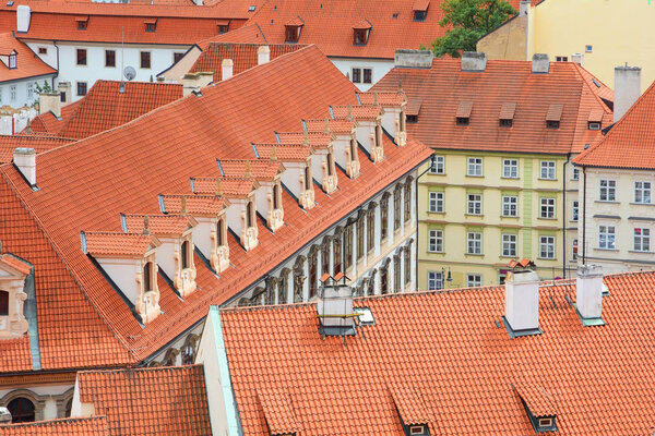 The old town's ceramic tiles rooftops, Prague, Czech Republic. Red Shingles Roof with attic and skylights windows.