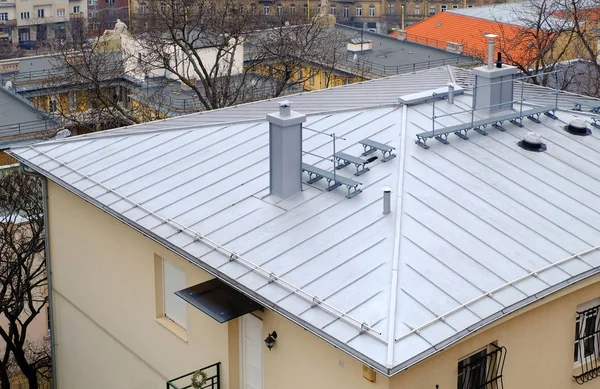 Modern Steel-Roof with Roof-Windows, Chimney and Fume Hoods. Technology of Transmission of Natural Light Through Hollow Tubular Light Guides.