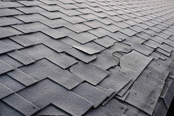 Close up view on Asphalt Roofing Shingles Background. Roof Shingles - Roofing. Shingles roof damage covered with frost