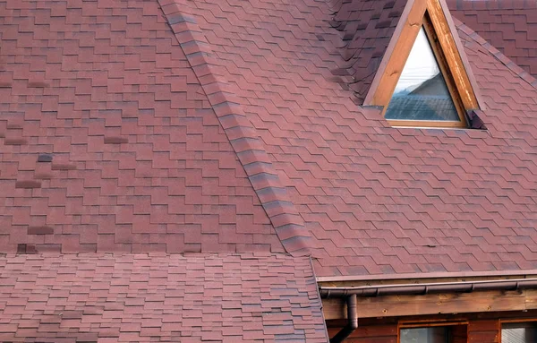 Roof Asphalt Shingles and Attic Mansard Window. Roofing Construction. Roofing Repair. Rain gutter.