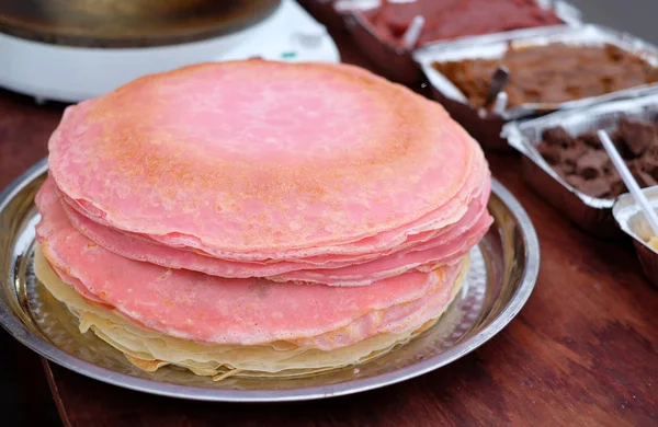 Many thin pancakes with crispy crust are stacked for breakfast and Shrovetide (Maslenitsa).