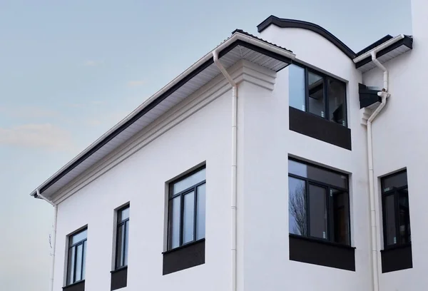 Newly installed construction frame house rain gutter system on the roof top