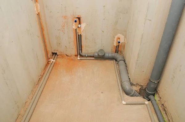 Domestic plumbing and sewage pipes connections in house construction.