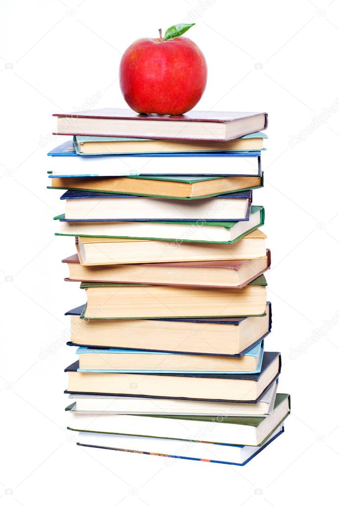 Books tower with apple isolated on white