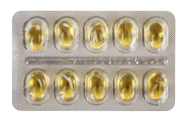 Dez comprimidos médicos amarelos embalados em uma embalagem blister — Fotografia de Stock