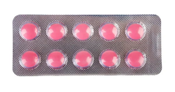 Tio rosa medicinska tabletter förpackade i en blisterförpackning — Stockfoto
