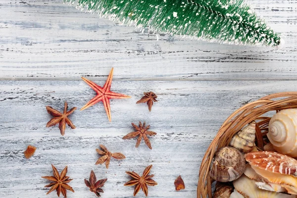 red stars, basket and Christmas pine on wooden background