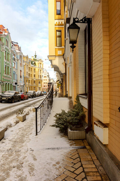 Winter snowy European street with colored houses
